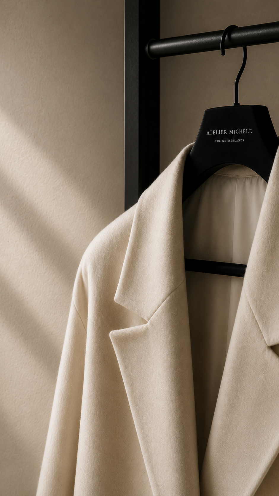 Atelier Michèle coat presented on a rail